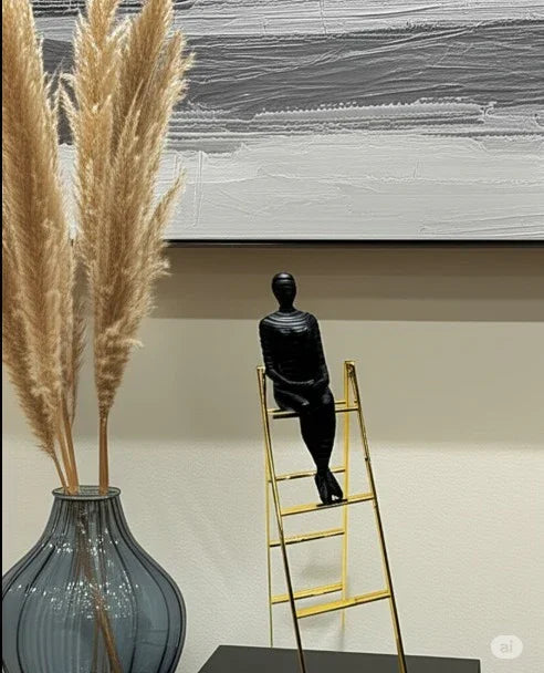 Man on ladder sculpture