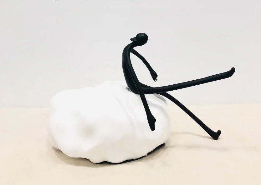 MAN SITTING ON A STONE