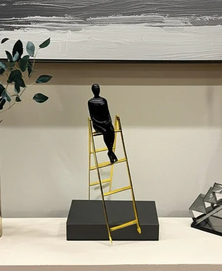 Man on ladder sculpture